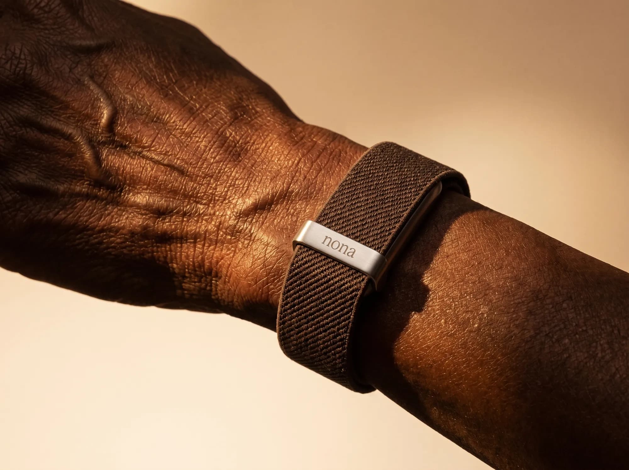 A fabric Nona band on an older person's wrist